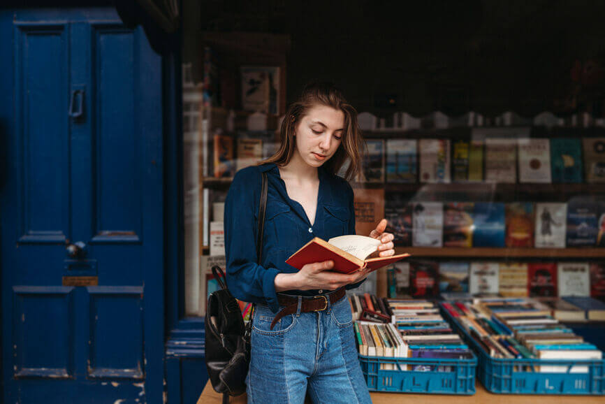girl in ripped lack jeans doing the college search on the computer